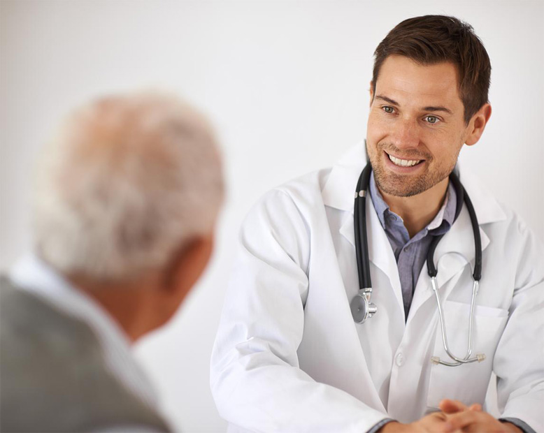 A young male doctor in a consultation with an elderly 